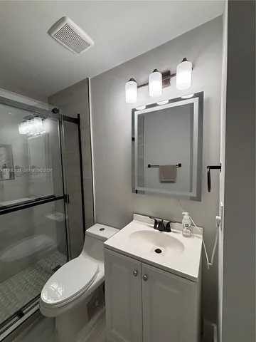 a bathroom with a shower and toilet