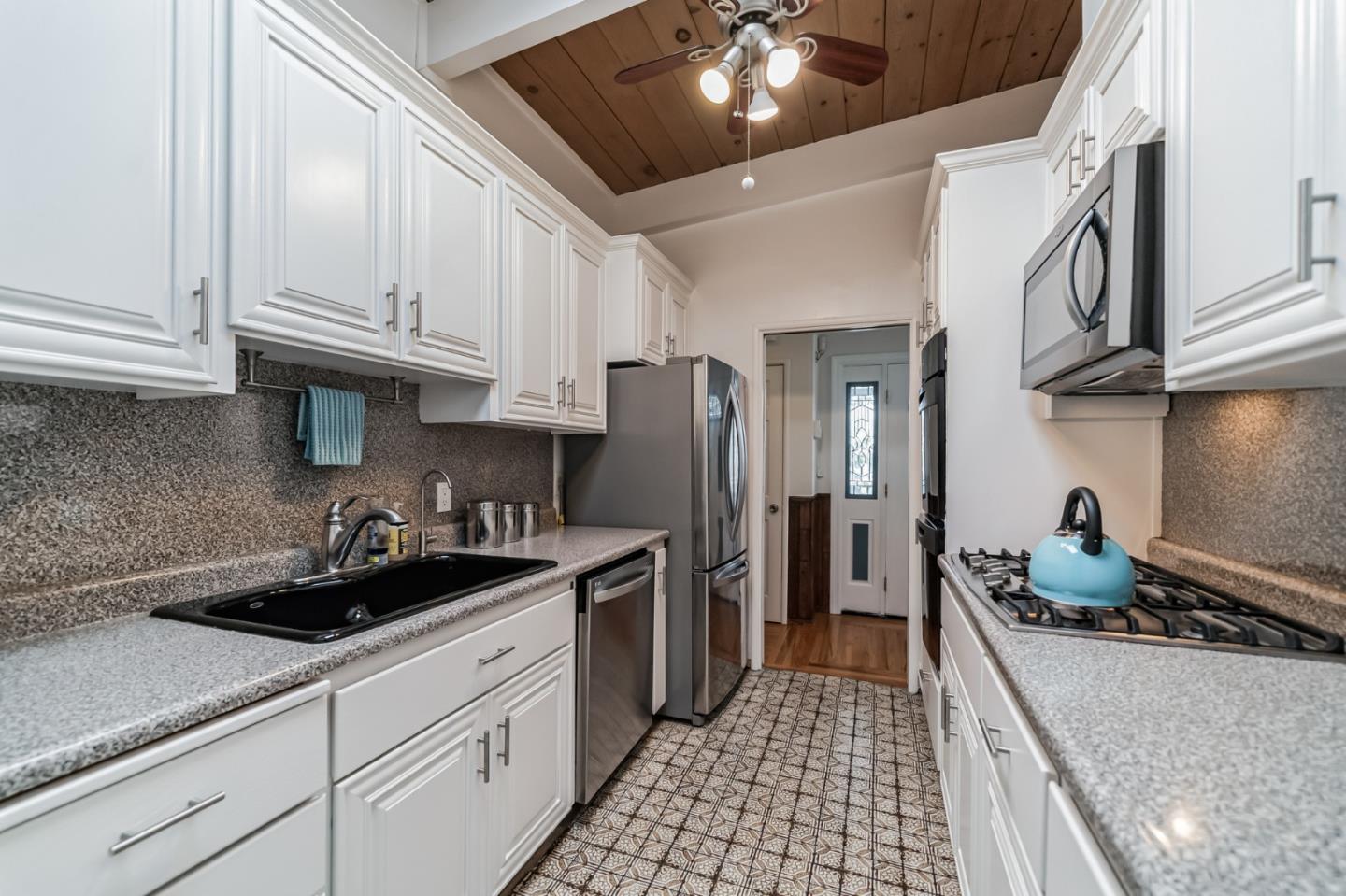 2933 Hardeman Street Hayward, CA 94541 - Photo 9 of 35 a kitchen with stainless steel appliances granite countertop a sink and cabinets