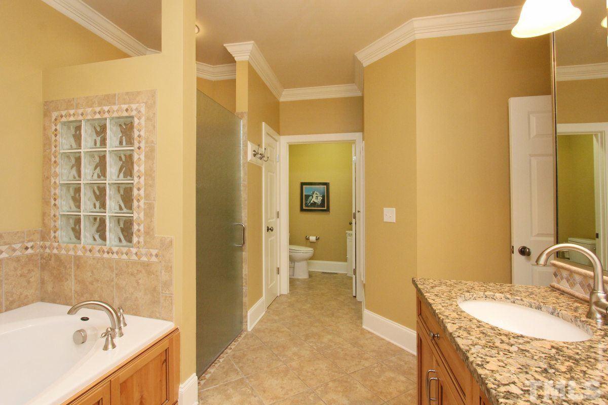 58 Lookout Ridge Pittsboro, NC 27312 - Photo 12 of 25 Master bathroom features dual vanities, granite counters, glass enclosed shower with zero entry. Perfect space for aging in place.