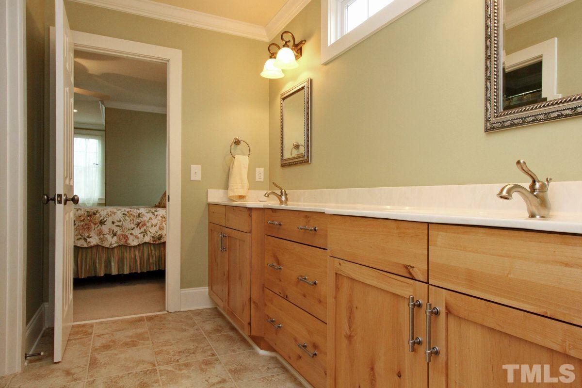 58 Lookout Ridge Pittsboro, NC 27312 - Photo 15 of 25 Guest bathroom is an oversized Jack and Jill with dual vanities and extensive cabinetry.