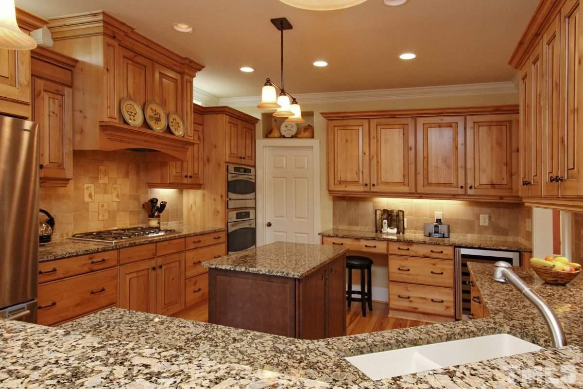 58 Lookout Ridge Pittsboro, NC 27312 - Photo 3 of 25 Beautiful custom cabinets make this kitchen warm and inviting. You will love the work space, even includes a desk/work area.
