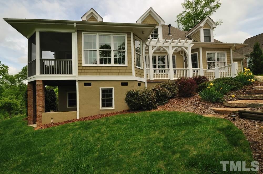 58 Lookout Ridge Pittsboro, NC 27312 - Photo 22 of 25 Beautiful exterior, well maintained lawn and landscaping, basement with exterior entrance perfect for storage.