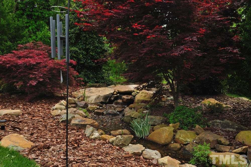 58 Lookout Ridge Pittsboro, NC 27312 - Photo 23 of 25 Serene pond in backyard with nearby patio overlooking the well manicured lawn.