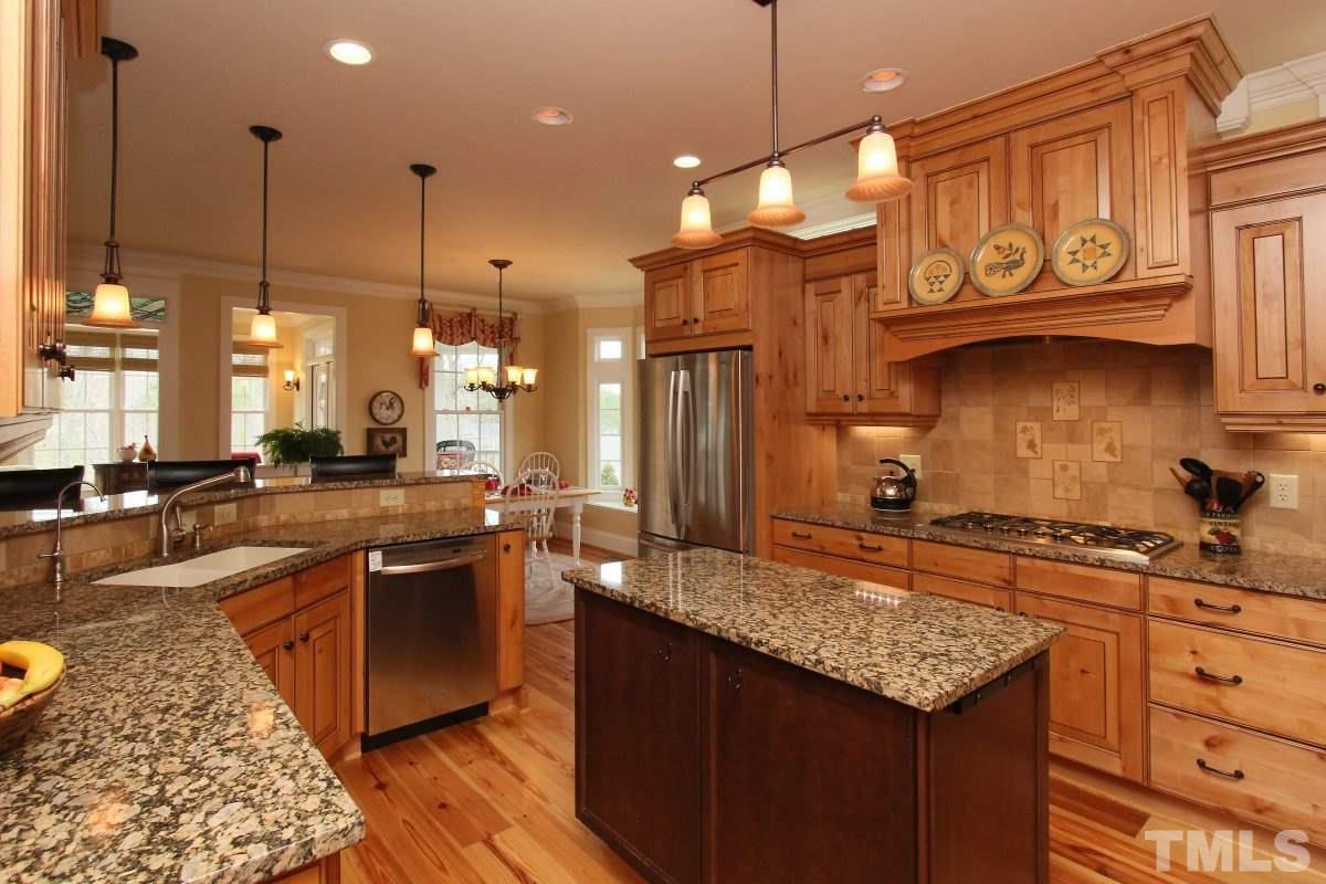 58 Lookout Ridge Pittsboro, NC 27312 - Photo 4 of 25 Gourmet kitchen features center island, granite countertops, stainless steel appliances, brand new dishwasher.