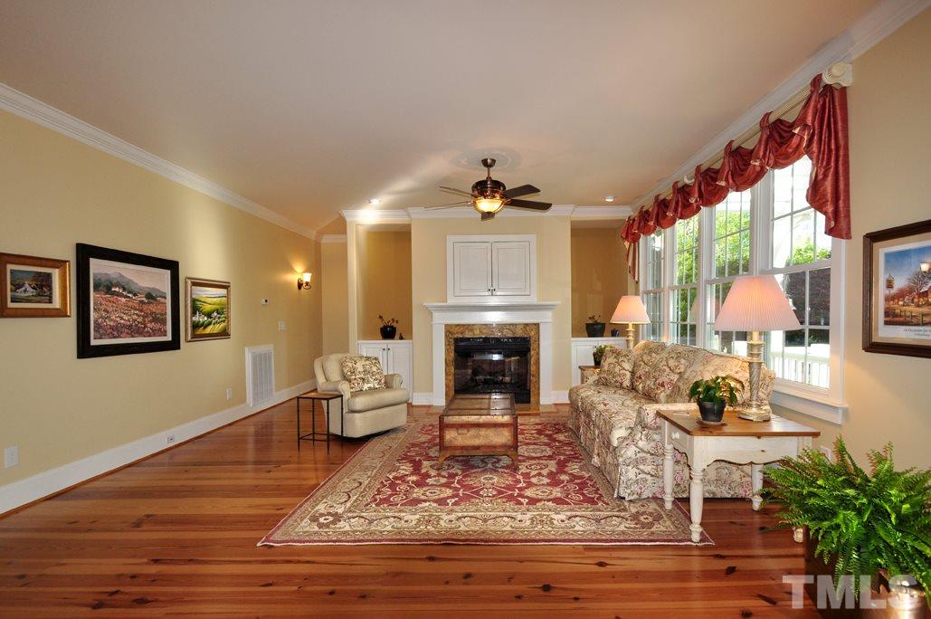 58 Lookout Ridge Pittsboro, NC 27312 - Photo 7 of 25 Great room features custom built in bookcases with storage, gas fireplace, beautiful windows overlooking backyard.