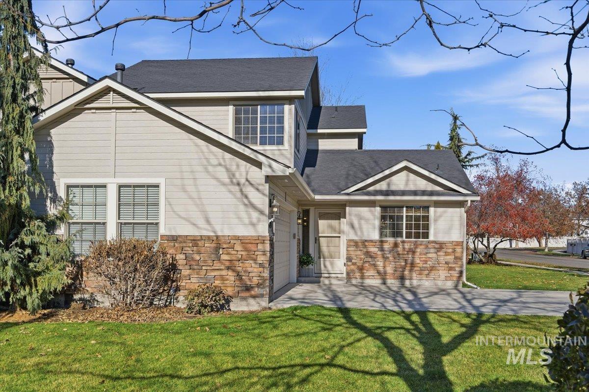 679 North Shadowfox Place Eagle, ID 83616 - Photo 2 of 37 View of front of home featuring a front lawn, stone siding, and a shingled roof