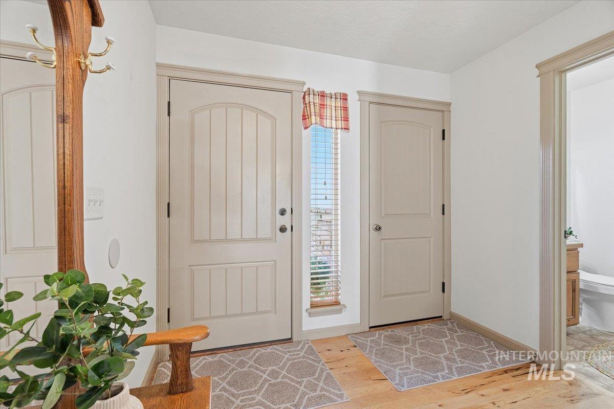 679 North Shadowfox Place Eagle, ID 83616 - Photo 4 of 37 Entrance foyer featuring light wood-type flooring and baseboards