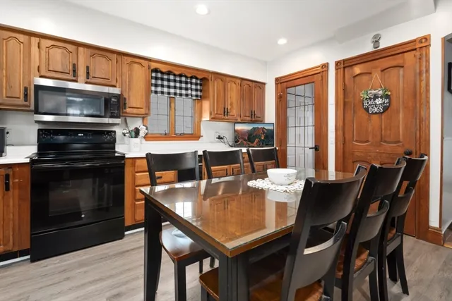 a dining table with chairs and flat screen tv