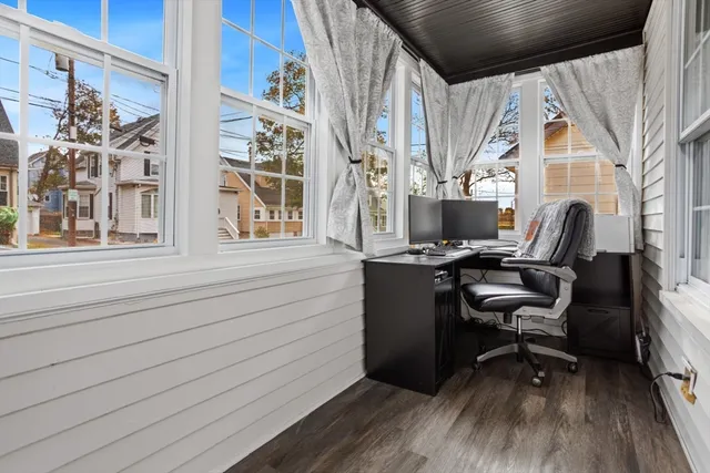 a view of a workspace with furniture and a window