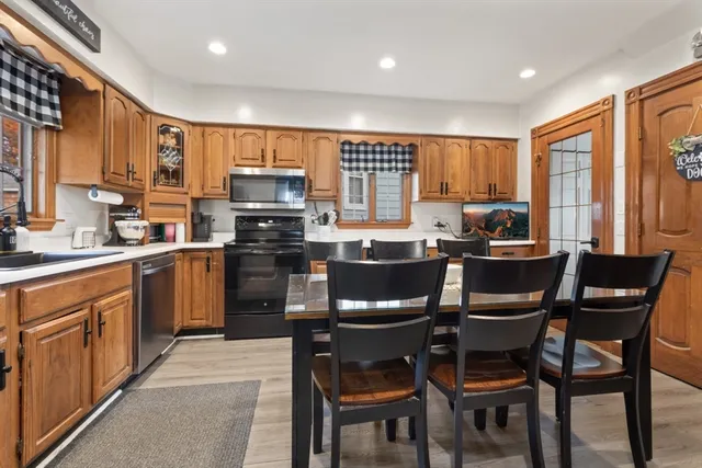 a kitchen with a table chairs microwave and cabinets
