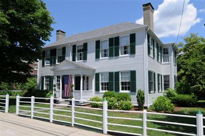 a view of a house with a large window and a table and chairs