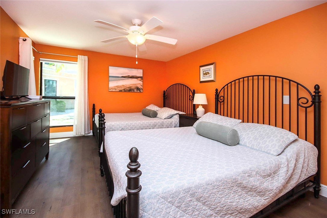 5117 Sea Bell Road, Unit B101 Sanibel, FL 33957 - Photo 13 of 23 a bedroom with two beds and a flat screen tv