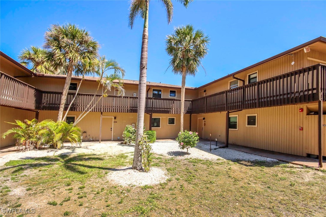 5117 Sea Bell Road, Unit B101 Sanibel, FL 33957 - Photo 18 of 23 a view of a house with a yard
