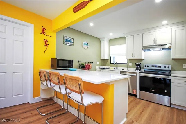 a kitchen with stainless steel appliances granite countertop a stove and a sink