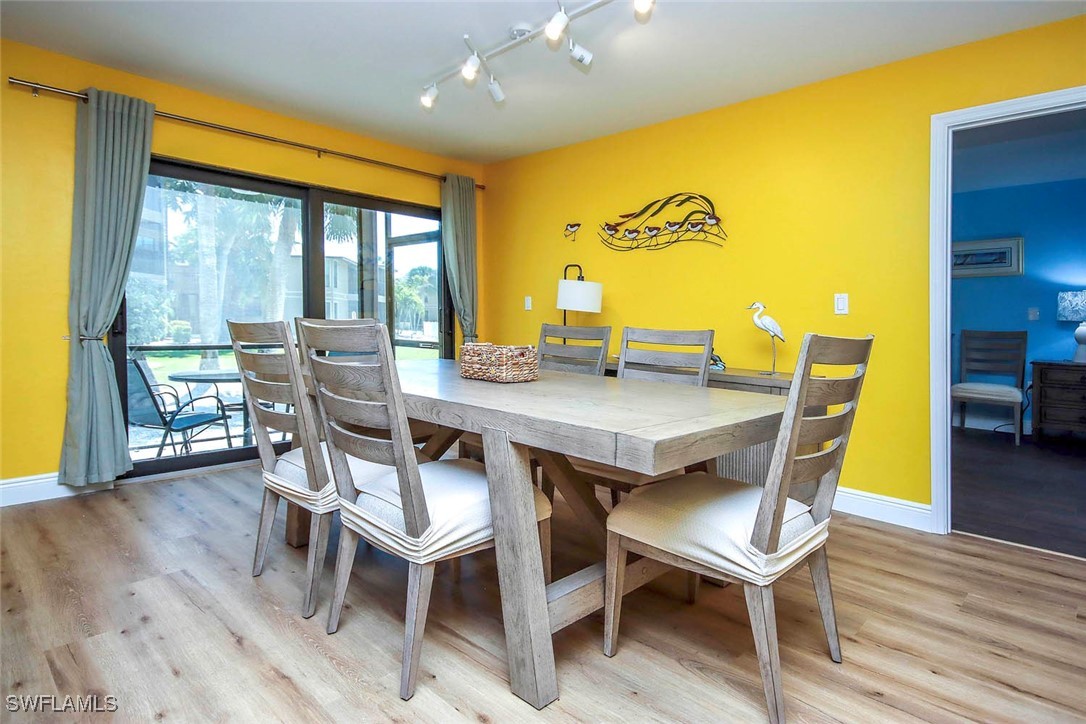 5117 Sea Bell Road, Unit B101 Sanibel, FL 33957 - Photo 7 of 23 a view of a dining room with furniture and wooden floor