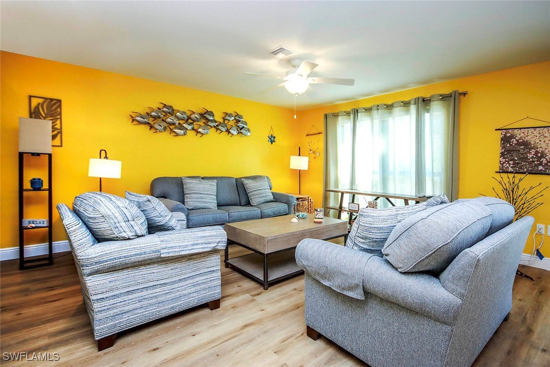 5117 Sea Bell Road, Unit B101 Sanibel, FL 33957 - Photo 8 of 23 a living room with furniture and a large window