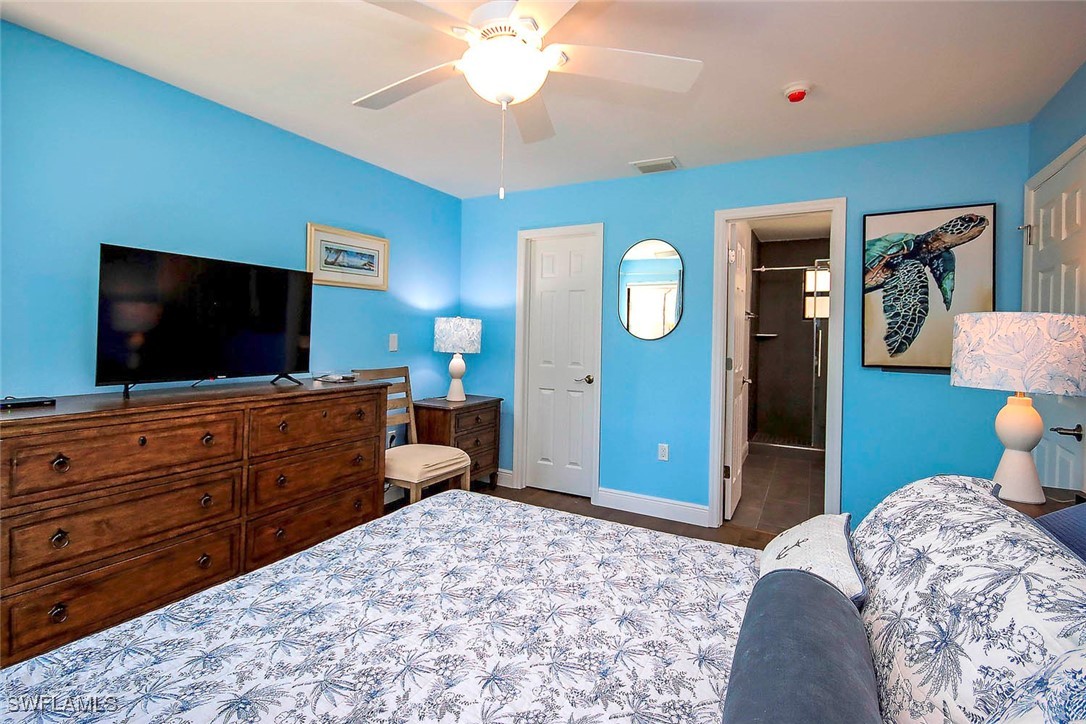 5117 Sea Bell Road, Unit B101 Sanibel, FL 33957 - Photo 10 of 23 a bedroom with a bed and a flat screen tv