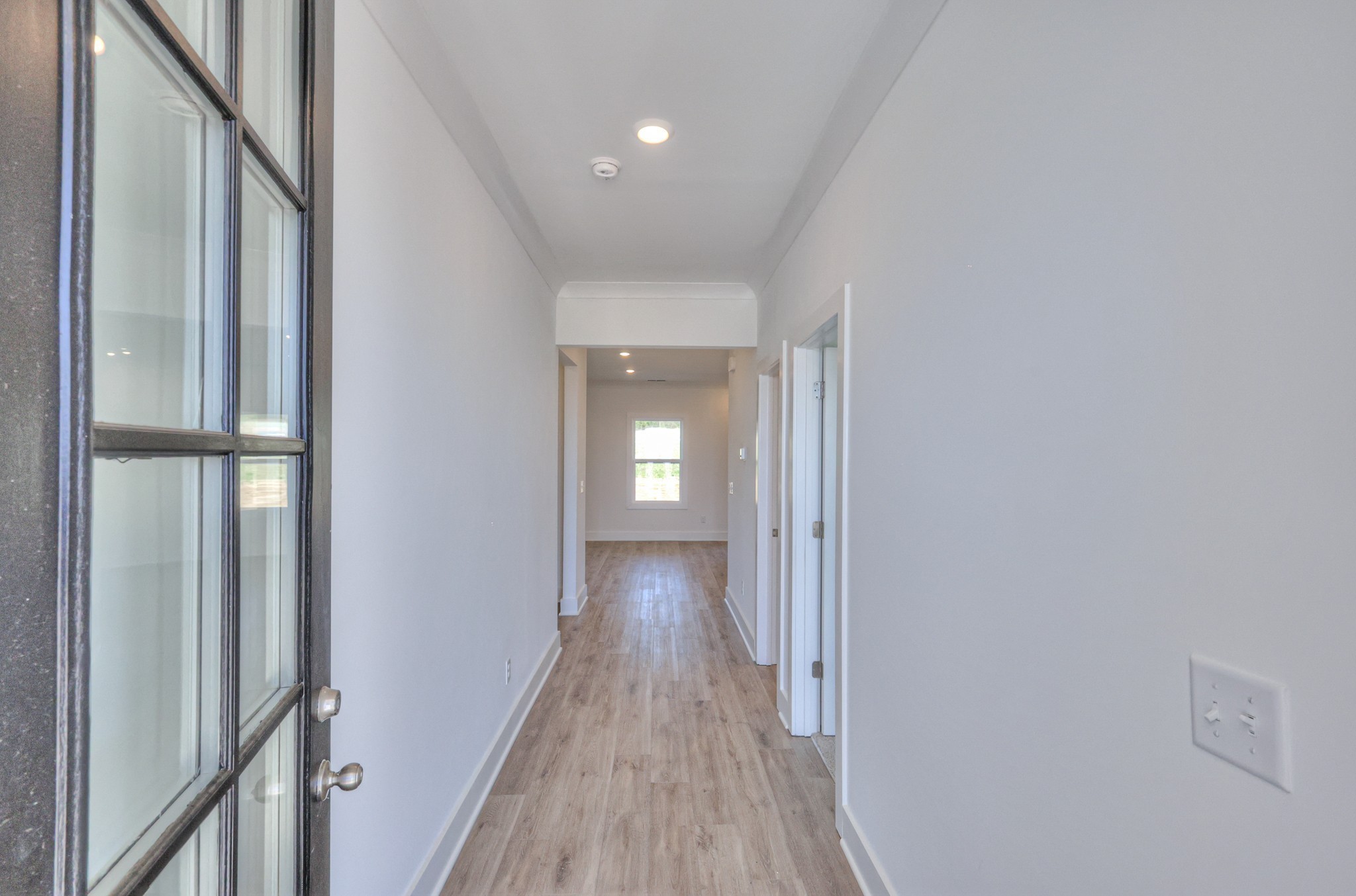 423 Duchess Boulevard Gallatin, TN 37066 - Photo 9 of 41 a view of a hallway with wooden floor and staircase