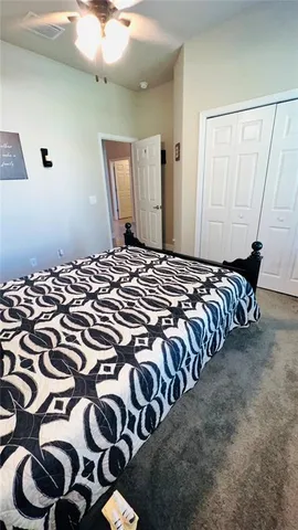 a bedroom with a bed and a painting on the wall