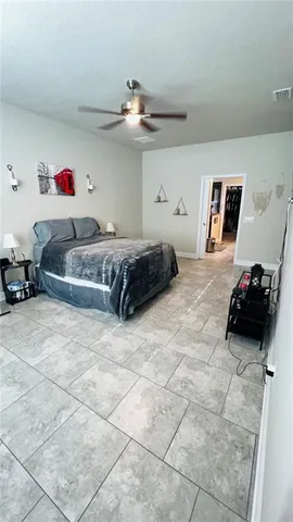 a bedroom with a bed and a view of kitchen