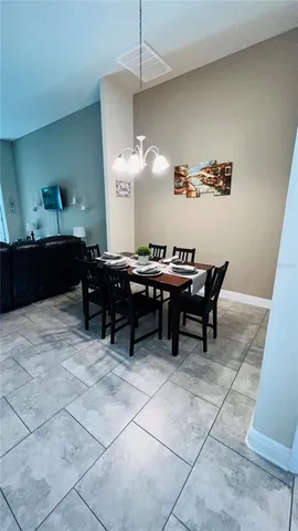 a room with a table chairs and a wooden floor