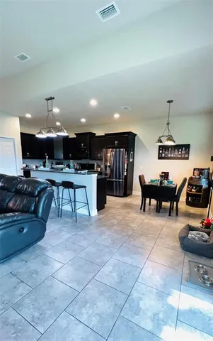 a living room with lots of furniture and kitchen view