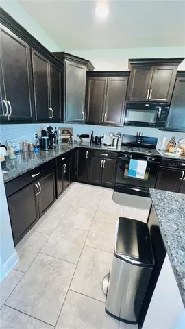 a kitchen with a stove and a refrigerator