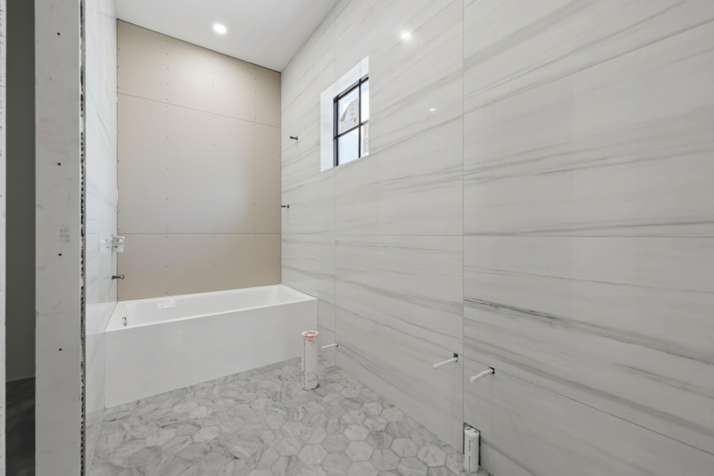 298 Northeast 8th Street Boca Raton, FL 33432 - Photo 25 of 48 a bathroom with a bathtub and a shower