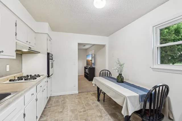 a hallway with a table and chairs