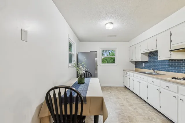 a kitchen with sink and cabinets