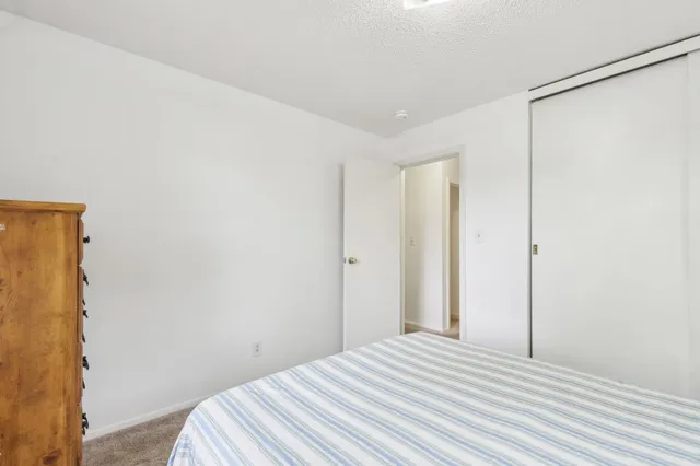 a view of a bedroom with wooden floor