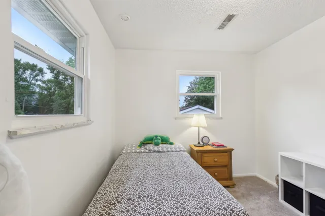 a view of a hallway to room with windows