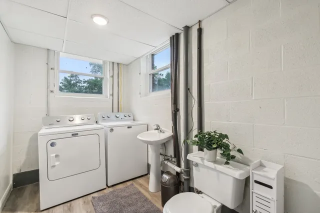 a view of bathroom with a toilet sink and mirror