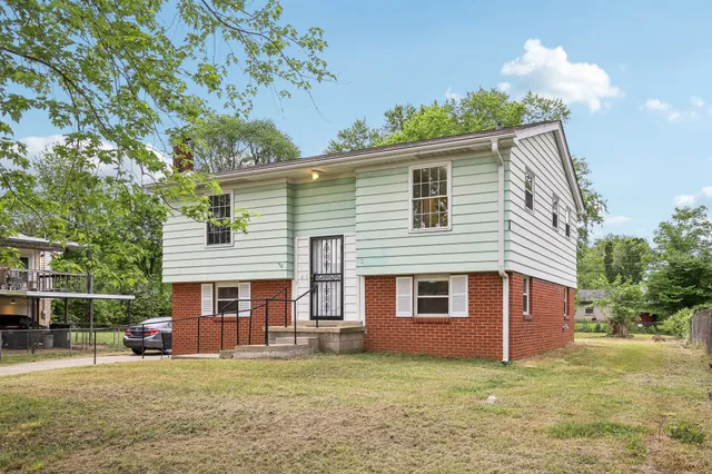 a front view of a house with a garden
