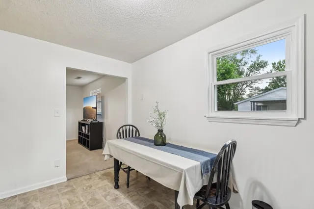 a view of a room that has a table and a chair
