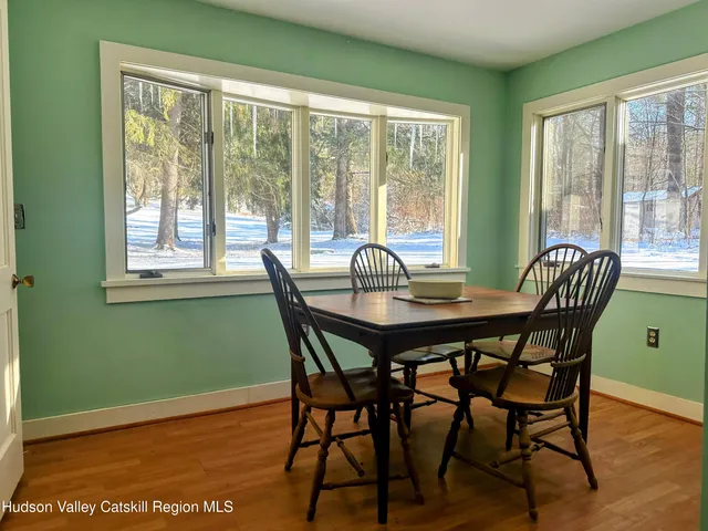 a view of a dining room with furniture and window