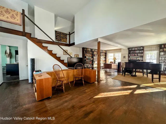 a dining room with furniture and wooden floor