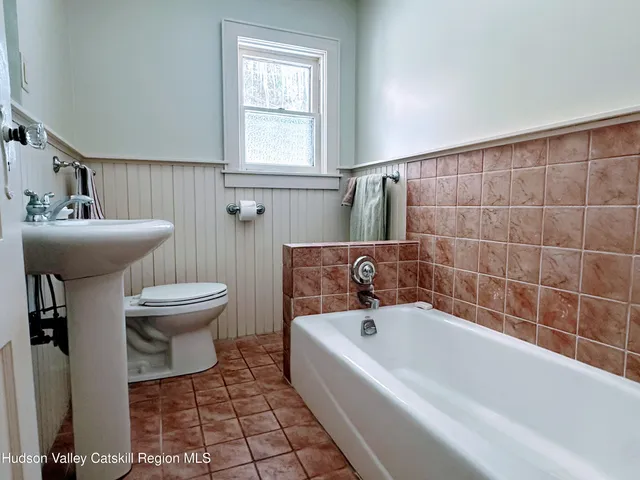 a bathroom with a sink a toilet and bathtub
