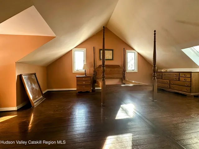 a view of a hall with stairs and a couch