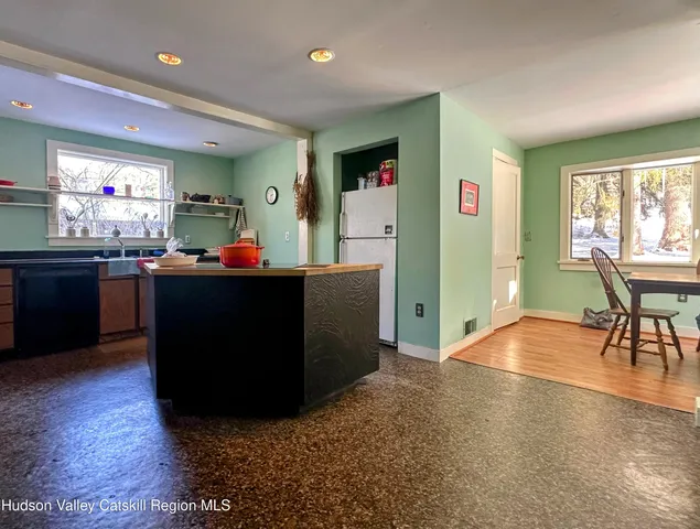 a living room with furniture and a dining room