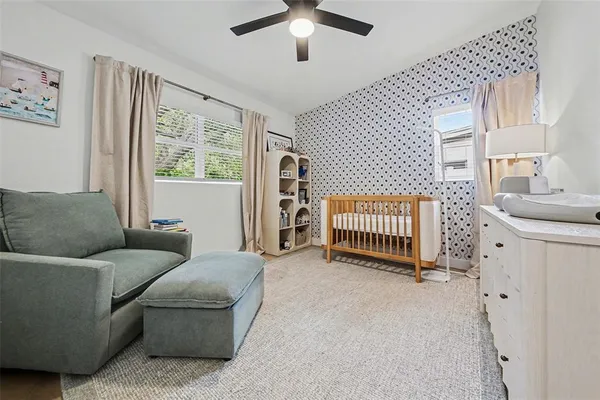 a living room with furniture a window and a flat screen tv