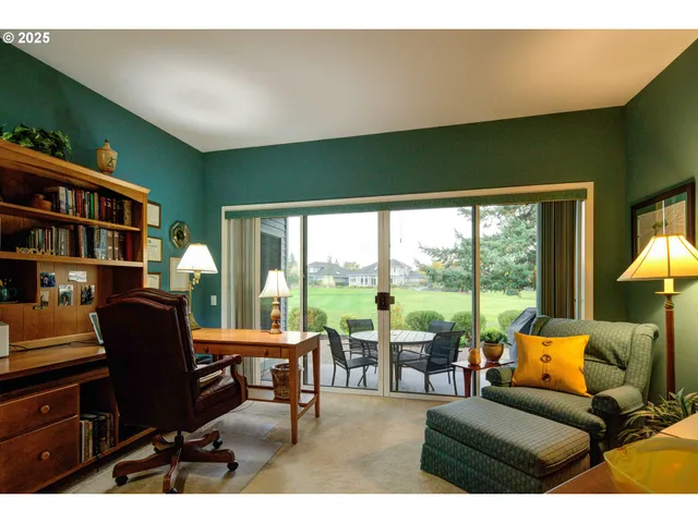 a living room with furniture tv and a floor to ceiling window