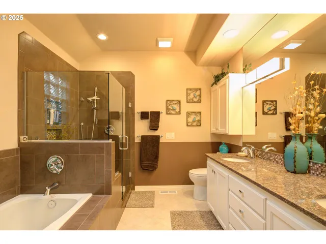 a spacious bathroom with a tub sink shower and mirror
