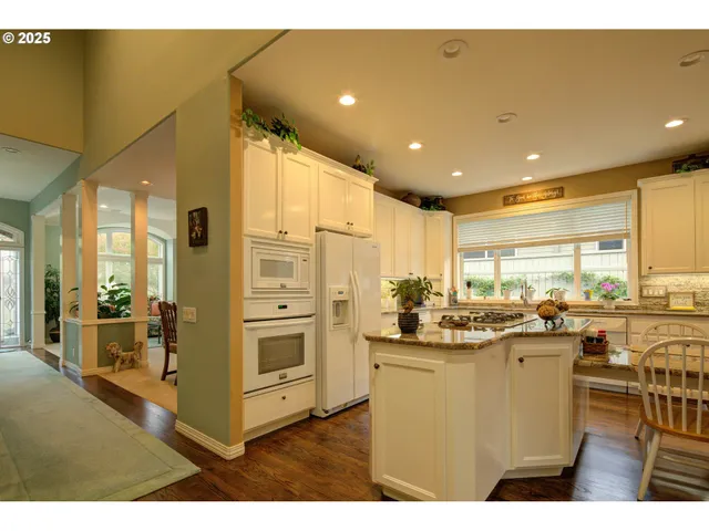 a kitchen with stainless steel appliances granite countertop a sink and cabinets