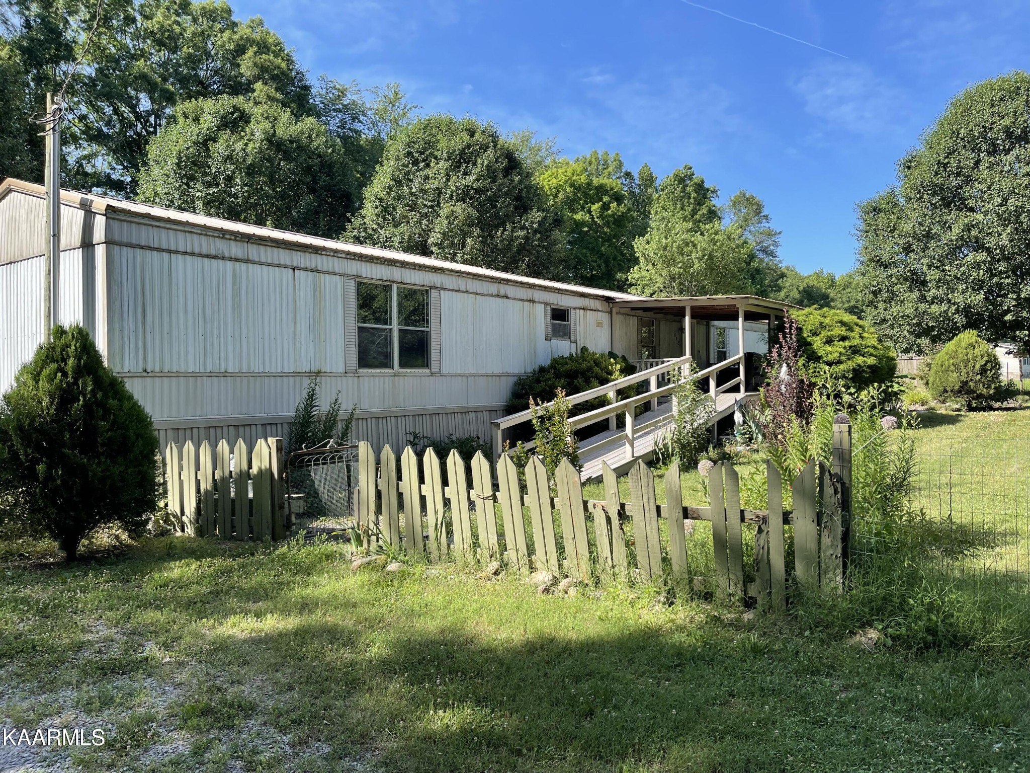 625 Miller Road Bybee, TN 37713 - Photo 13 of 34 a front view of a house with a yard table and chairs
