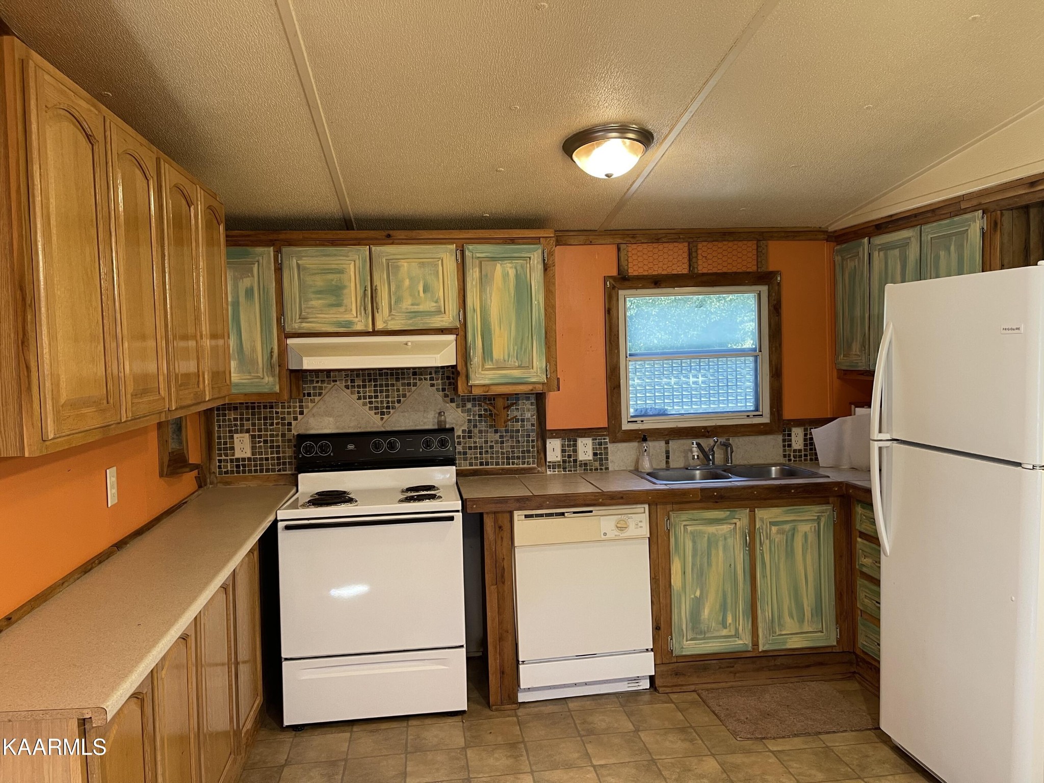 625 Miller Road Bybee, TN 37713 - Photo 25 of 34 a kitchen with a stove a sink and a refrigerator