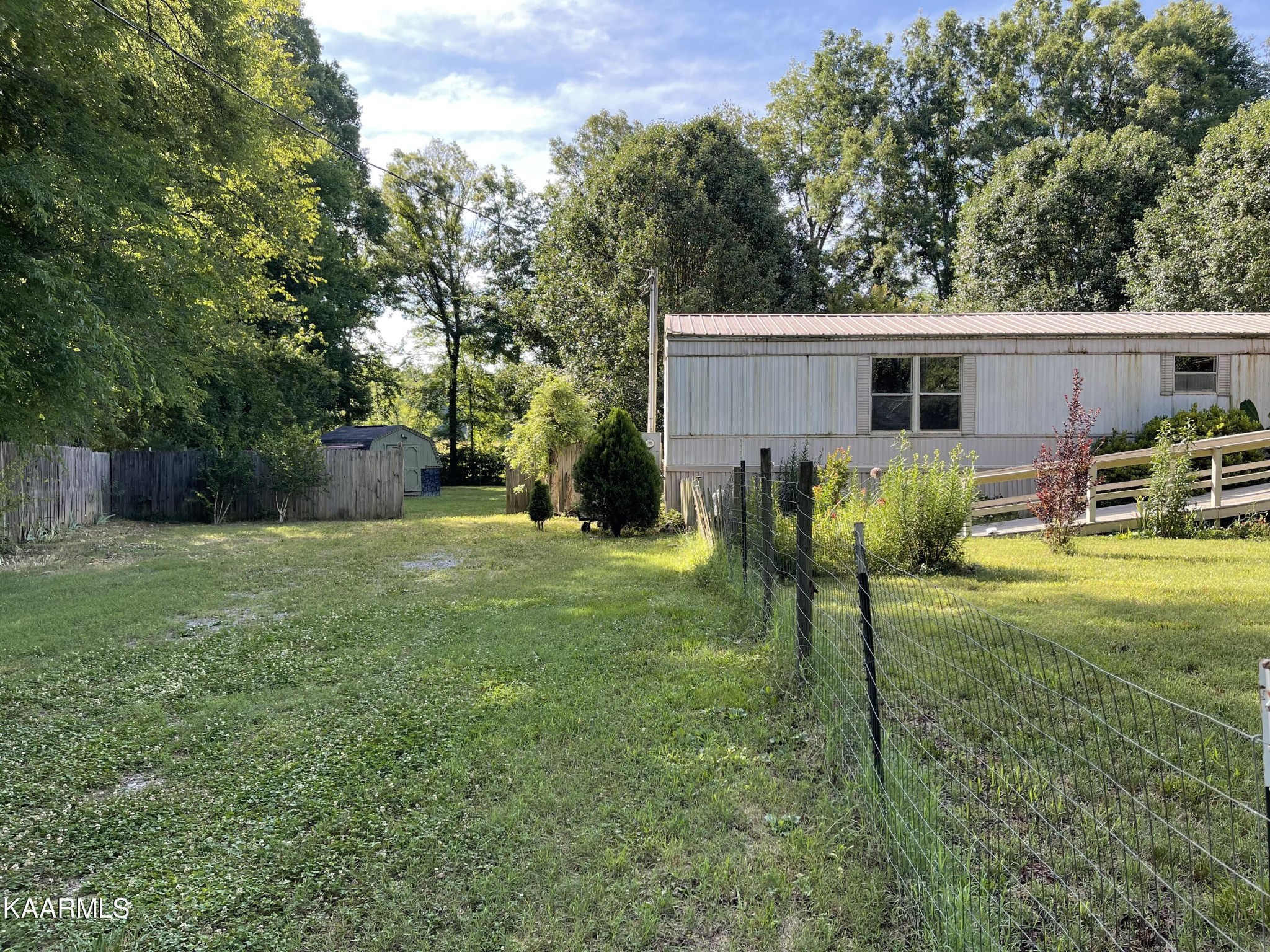 625 Miller Road Bybee, TN 37713 - Photo 3 of 34 a view of a backyard with table and chairs potted plants and large tree