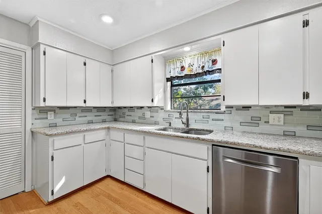 a kitchen with stainless steel appliances granite countertop a sink and cabinets
