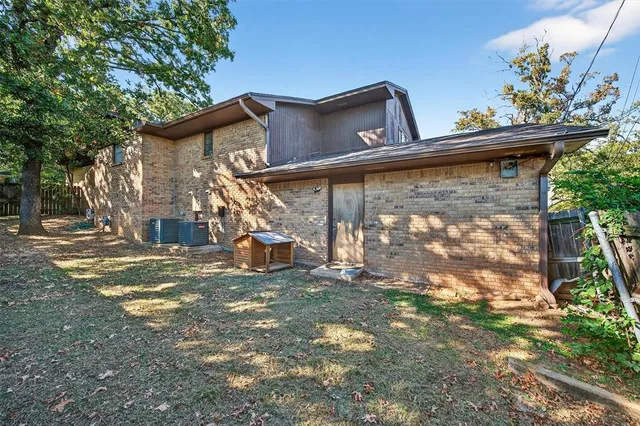a backyard of a house with table and chairs