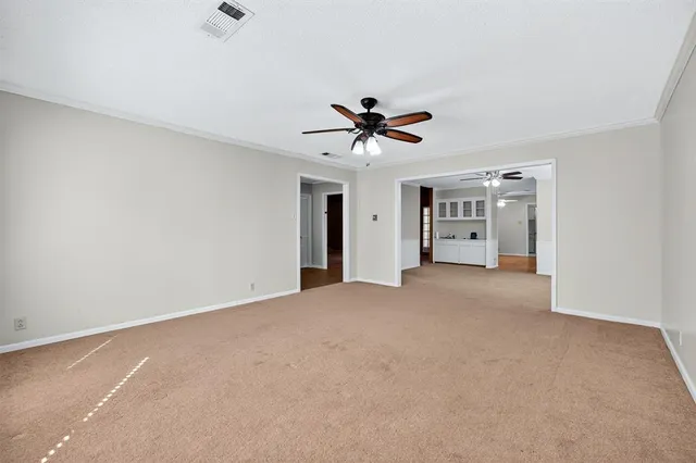 a view of a big room with closet and a chandelier fan